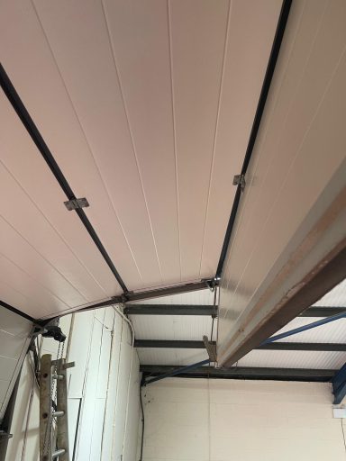 Sectional Overhead Door- Rollers supporting the panels fallen out of the tracks. Reason- Poor maintenance